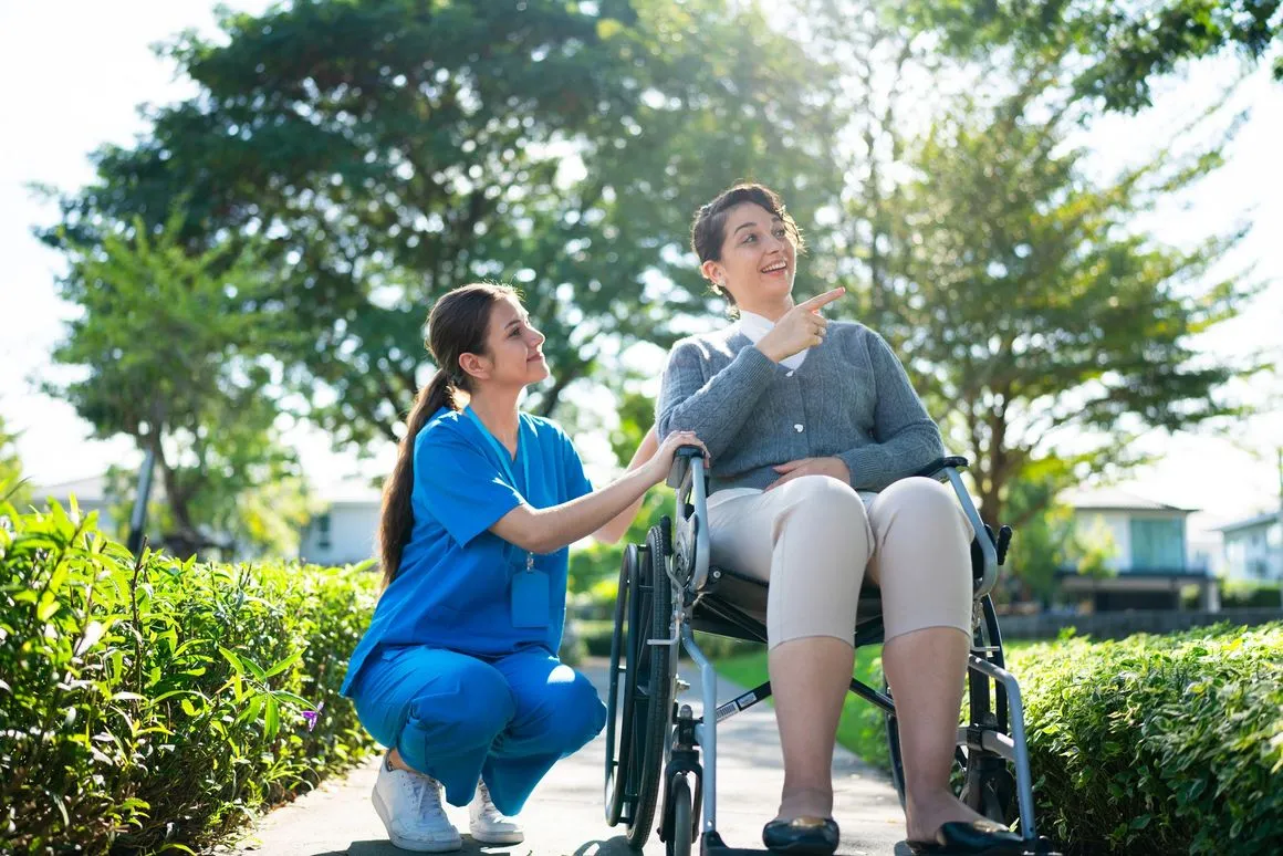 Home care professional supporting a client outdoors